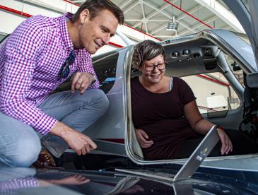 Researchers looking at a laptop together.