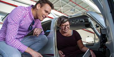 Researchers looking at a laptop together.