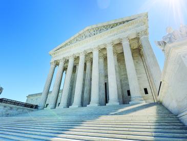 United States Supreme Court building, with majestic columns, on a sunny day.